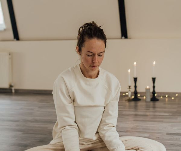 A person sitting in a calm meditative pose, symbolizing inner harmony.