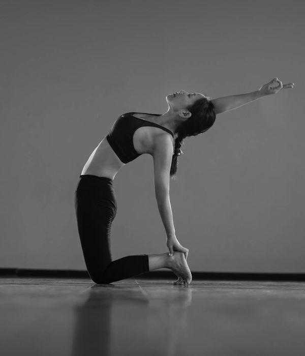 Woman in a graceful yoga pose, illustrating flow and flexibility.